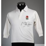 A child's England replica rugby shirt autographed by Martin Johnson