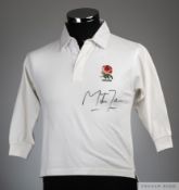 A child's England replica rugby shirt autographed by Martin Johnson