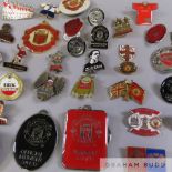 A collection of various Manchester United pin badges