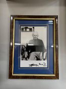 A framed and mounted black and white photograph of Sir George Martin