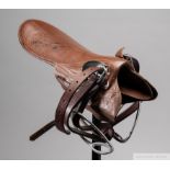 Signed Lester Piggott lightweight jockey's saddle, signed in black marker, the brown saddle