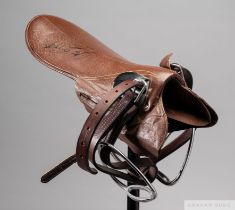 Signed Lester Piggott lightweight jockey's saddle, signed in black marker, the brown saddle