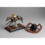 Painted cast-metal racehorse and jockey in full gallop,