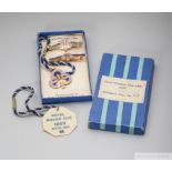 A boxed trio of matching Royal Windsor Racecourse badges, consisting of a gentleman's and two