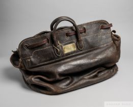 Tommy Weston's travelling leather saddle bag, the deep, heavy leather bag set with a brass plaque