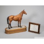 Royal Worcester porcelain model of the racehorse Arkle modelled by Doris Lindner, on wooden stand,