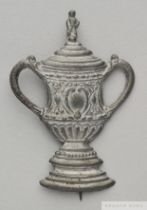 A miniature white-metal F.A.Cup lapel badge