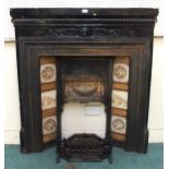 A Victorian black painted cast iron fire insert/surround with fire basket, adjustable hood flanked