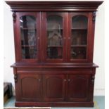 A 20th century mahogany glazed bookcase with moulded cornice over three glazed doors over three