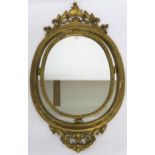A gilt framed rococo style oval wall mirror, 134cm high x 80cm wide  Condition Report:Available upon