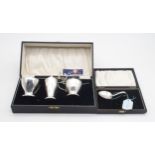 A three piece Art Deco silver cruet set, with blue glass liners, by S Blanckensee & Sons Ltd,