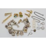 A silver charm bracelet, ingot pendant, and costume jewellery Condition Report:Not available for