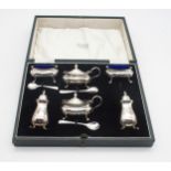 A George V five piece silver cruet set, with two open salts, two casters, two must pots, four