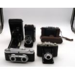 Various vintage cameras, including a Wirgin Stereo camera, a Moskva-5 medium format folding