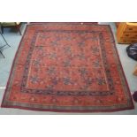 A pink ground oriental rug with all-over floral lozenge design and floral borders, 264cm x 266cm