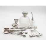 A collection of silver including a large silver topped cut glass scent bottle, by Elkington & Co,