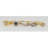 Four 18ct gold diamond rings, one is missing two stones, and a diamond and sapphire cluster ring,