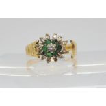 An 18ct emerald and diamond flower ring, (af) size M, weight 3.8gms Condition Report:Available