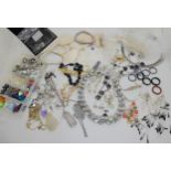 A collection of silver and white metal wire, findings, Swarovski, and Pandora beads for making