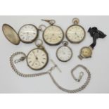 A collection of silver, pocket watches, fob watches, and a wrist watch, in various states of repair.
