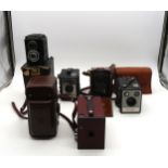A Seagull 4B1 twin-lens reflex camera, a Voigtlander Brilliant pseudo-TLR box camera, a Lomo Lubitel