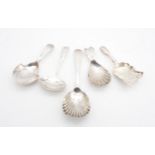 A collection of George III silver caddy spoons; including a Scottish Old English pattern shell