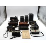 Vintage cameras, including various Box Brownies, Ensign, Kodak, Zorki and Polaroid  Condition