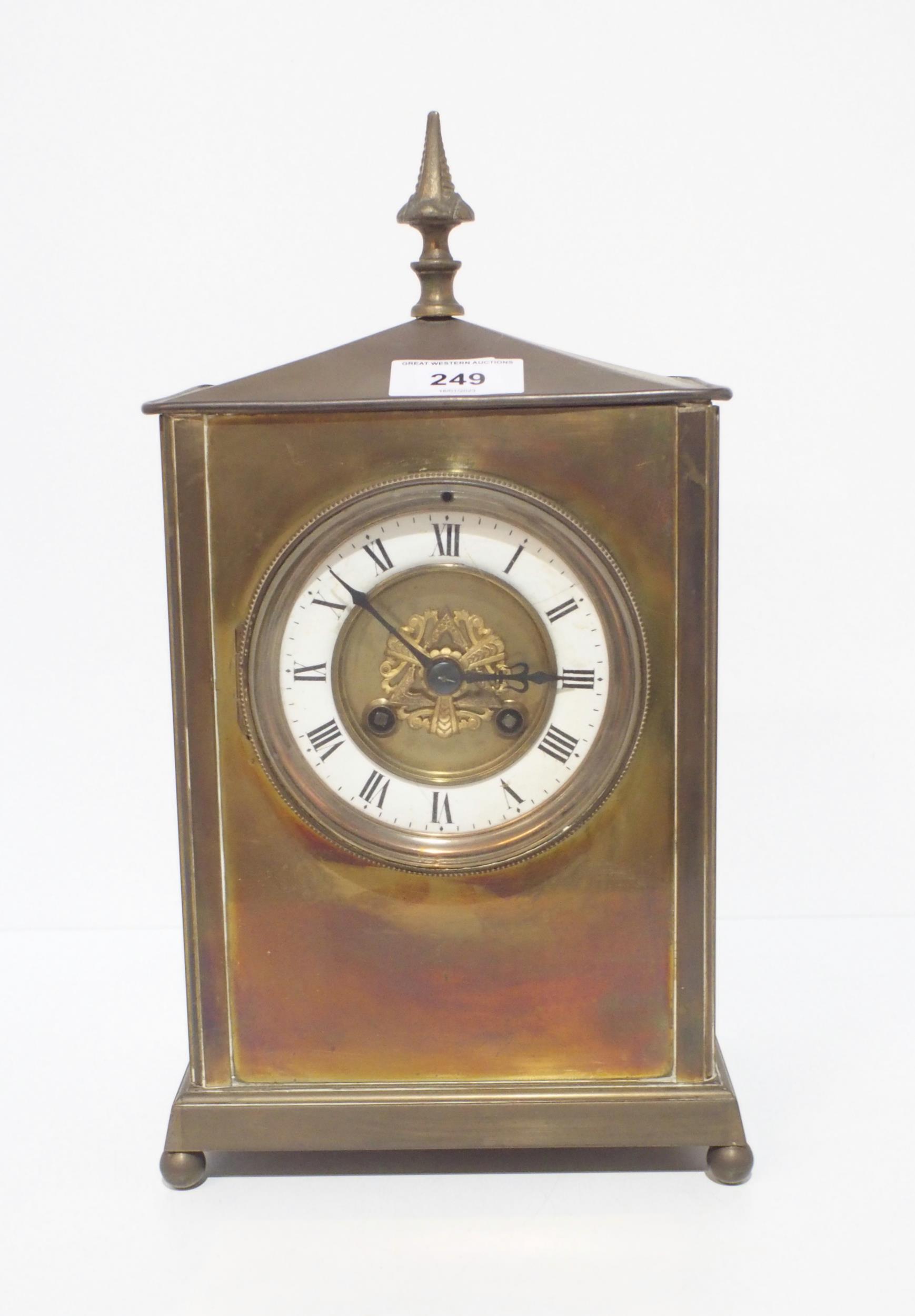 A French brass mantle clock, the dial with enamelled chapter ring with roman numerals, the
