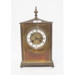 A French brass mantle clock, the dial with enamelled chapter ring with roman numerals, the