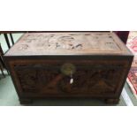A 20th century carved Oriental camphorwood blanket chest on shaped block feet, 58cm high x 109cm