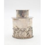 An Edwardian silver tea caddy, of oval form, with cast decoration of cherubs frolicking amongst