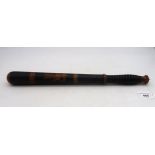 A polychrome-decorated police truncheon bearing "VR" cipher and numbered 838 above handle, likely