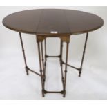 A 19th century mahogany Sutherland table with oval drop leaf top on turned stretchered supports,