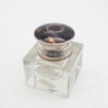 A George V silver tortoiseshell glass inkwell, of cube form,  the tortoiseshell inlaid with a