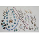 A box full of silver and costume jewellery to include a pair of rainbow titanium earrings, a pair of