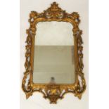 A gilt framed rococo style wall mirror, 109cm high x 67cm wide Condition Report:Available upon