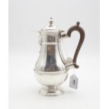 A Victorian silver coffee pot, of baluster form with banded sections, on a footed circular base,