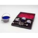 A cased set of Victorian open silver salts, the galleries with pierced openwork, on four ball