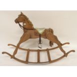 A 20th century pine child's rocking horse with cushioned leather saddle, bridle and stirrups, 99cm