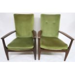 A pair of mid 20th century Parker Knoll stained teak framed armchairs with green velour