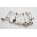 A collection of mainly sifter spoons, including a George III Old English example, with berried bowl,
