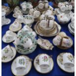 A set of ten Royal Worcester coffee cans and saucers all decorated with different flowers, two extra