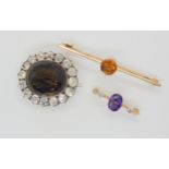 A 9ct gold citrine set brooch, together with an amethyst and diamond brooch and a yellow and white