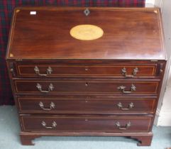 A 19th century mahogany writing bureau with fitted fall front writing compartment over four