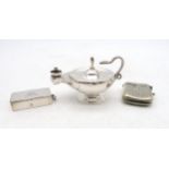A George V silver table lighter in the form of a genie's lamp, with a snake handle, by Deakin &
