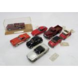 A small collection of Franklin Mint scale model vehicles, including an Aston Martin DB5 in Perspex