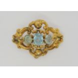 A Victorian yellow metal brooch set with three blue glass gems, length 5.3cm, weight 8.2gms