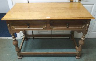 A 20th century honeyed oak two drawer hall table on stretchered turned supports, 78cm high x 104cm