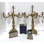 A pair of gilt metal candelabra with glass drops, together with a metal desk set Condition Report: