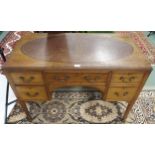 A 20th century mahogany writing desk with oval skiver over single long drawer flanked by two short